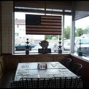 an american flag hanging in the window