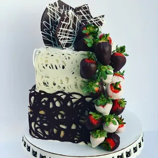  a cake with strawberries and chocolate covered strawberries