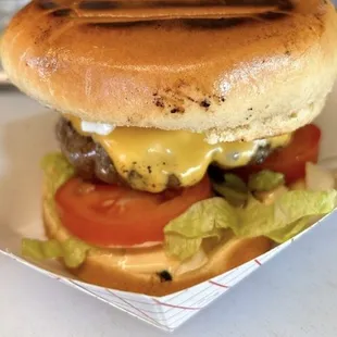 a hamburger with cheese and lettuce