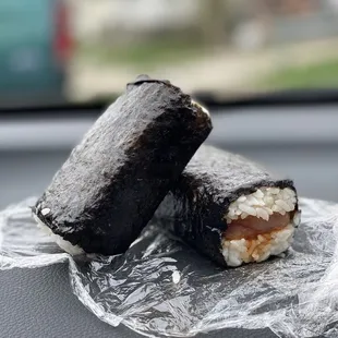 two pieces of sushi on a wrapper
