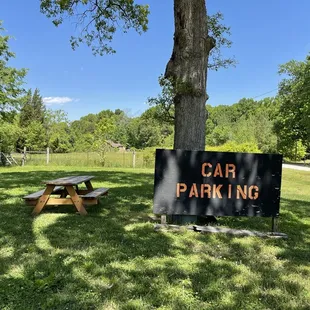 a car parking sign and picnic table