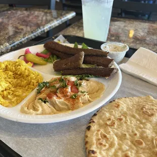 Gyro plate with rice pilaf and hummus.