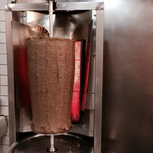 a kebab being cooked in a commercial kitchen