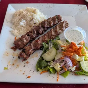 Adana kebab, rice, and salad.