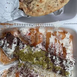 Beef kebab with rice, potatoes, and Pita Bread