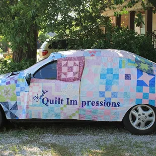 Quilted car cover made for the Miracle Block Project. Quilt blocks are make by quilters from all around Kansas...