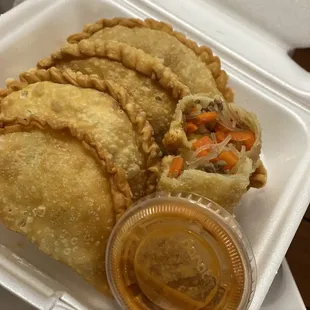 a variety of food items in a styrofoam container