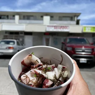 a person holding a bowl of food