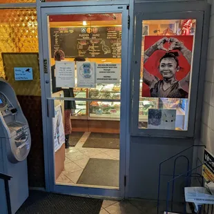 Enter through this door. The maximum number of customers in the store is four.