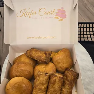 The goodies togo.  Bbq pork bun, beef curry bun, chicken pastries, and pork pastries.