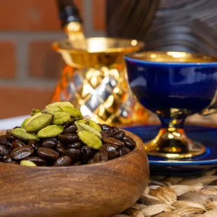 a cup of coffee and a bowl of nuts