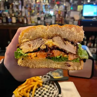 a hand holding a sandwich