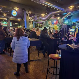 The tables and chairs in front of the bar