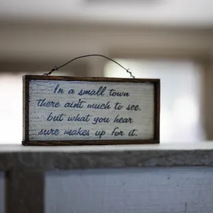 a small wooden sign on a counter