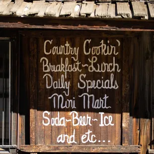 a wooden building with a sign on it