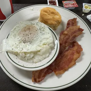 Over easy eggs bacon and amazing biscuits.