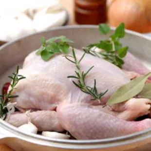 a raw chicken in a pan