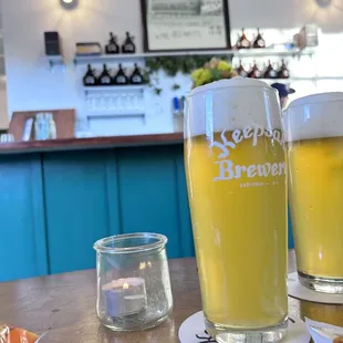 two glasses of beer on a table