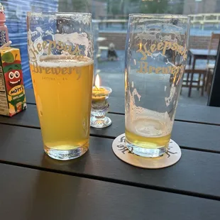 two glasses of beer on a table