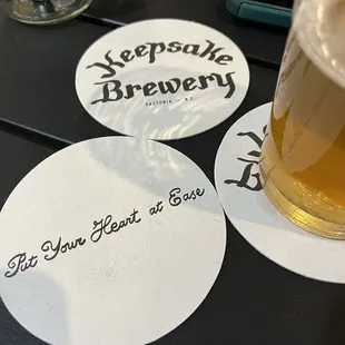 a glass of beer and coasters