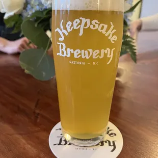 a pint of beer on a coaster