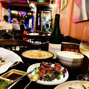 a table of food and a glass of wine