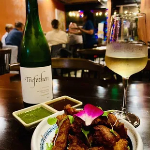 a plate of food and a glass of wine