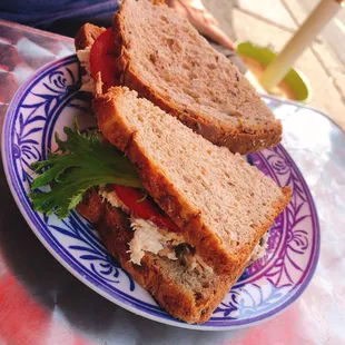 a sandwich on a blue and white plate
