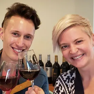 a man and a woman holding wine glasses