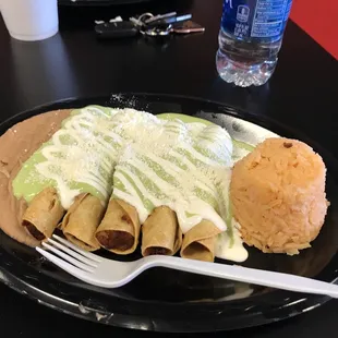 Potato flautas, traditional style with guacamole sauce, sour cream, and cheese. Served with rice and beans.