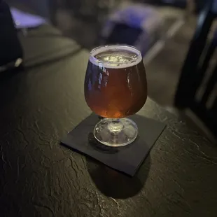 a glass of beer on a table