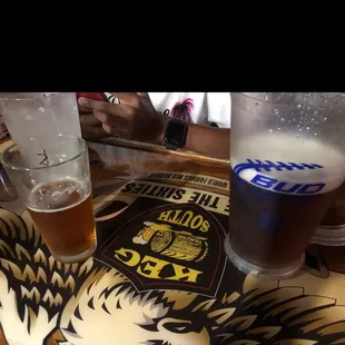 a glass of beer and a glass of beer on a table