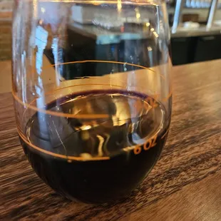 a glass of wine on a wooden table