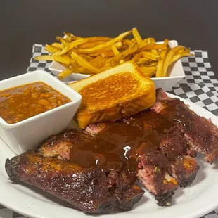 a plate of ribs and french fries