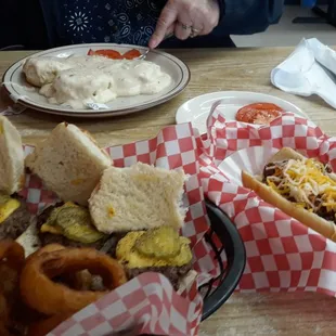 a hot dog with cheese and onion rings