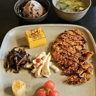 Lucnh set - pork katsu, miso soup, multi grain rice, slow cooked chicken, tomatoes, hijiki, tamago
