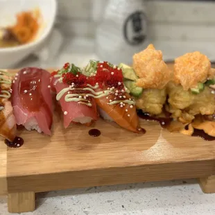 a variety of sushi on a cutting board