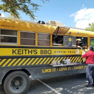 a man standing in front of a food truck