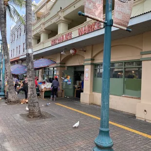 a street scene with people walking on the sidewalk