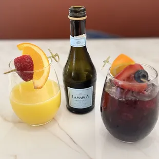 LEFT: White peach bellini (bottle in center). RIGHT: Wild berry sangria