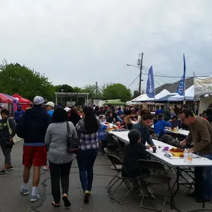 a crowd of people walking through a market
