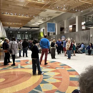 a crowd of people standing in a hall