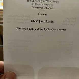 a hand holding a piece of paper