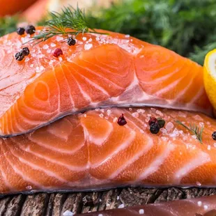 two portions of salmon on a cutting board