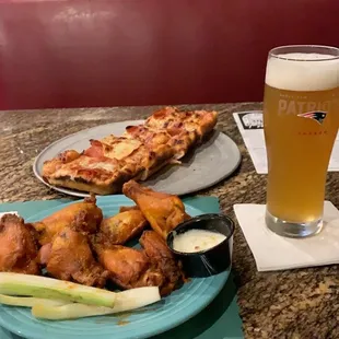 Deep dish pepperoni pizza, wings, draft blue moon