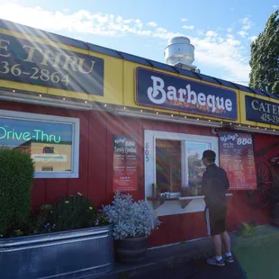 a man standing outside of a restaurant