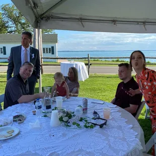 Family enjoying wedding reception with a beautiful backdrop!