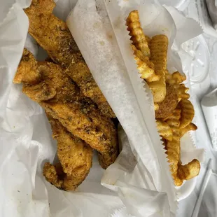 Jerk chicken tenders with crinkle cut fries and hush puppies