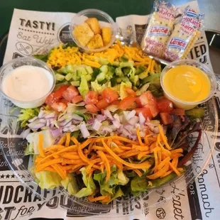 Full Garden Salad -
A blend of iceberg lettuce &amp; spring mix topped w/ cheddar cheese, tomatoes, onions, cucumbers, carrots, &amp; croutons