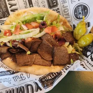 Greek Gyro Meal -
Pita topped w/ gyro slices, tzatziki sauce, feta, lettuce, tomatoes, onions, and kalamata olive slices.
